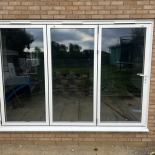 White three-pane bifold doors