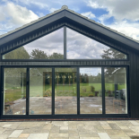 Black aluminium bifold doors and gable glazing fitted by WDC Anglia