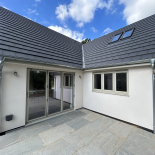 Grey uPVC windows and bifold doors on a new-build home, fitted by WDC Anglia