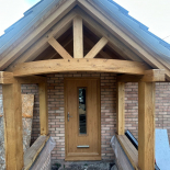 Oak-effect composite door under an oak porch