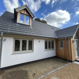 Grey uPVC windows and bifold doors on a new-build home, fitted by WDC Anglia