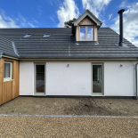 Grey uPVC windows and bifold doors on a new-build home, fitted by WDC Anglia